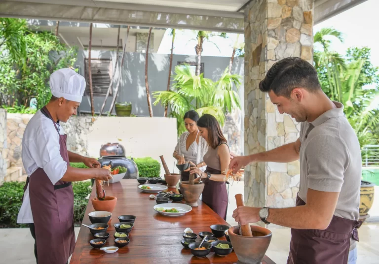 chef demonstrating to people at cooking class in samui